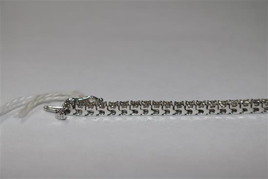 An 18ct white gold and diamond line bracelet, set with fifty four stones with an estimated total weight of 5.00cts, 17.5cm.